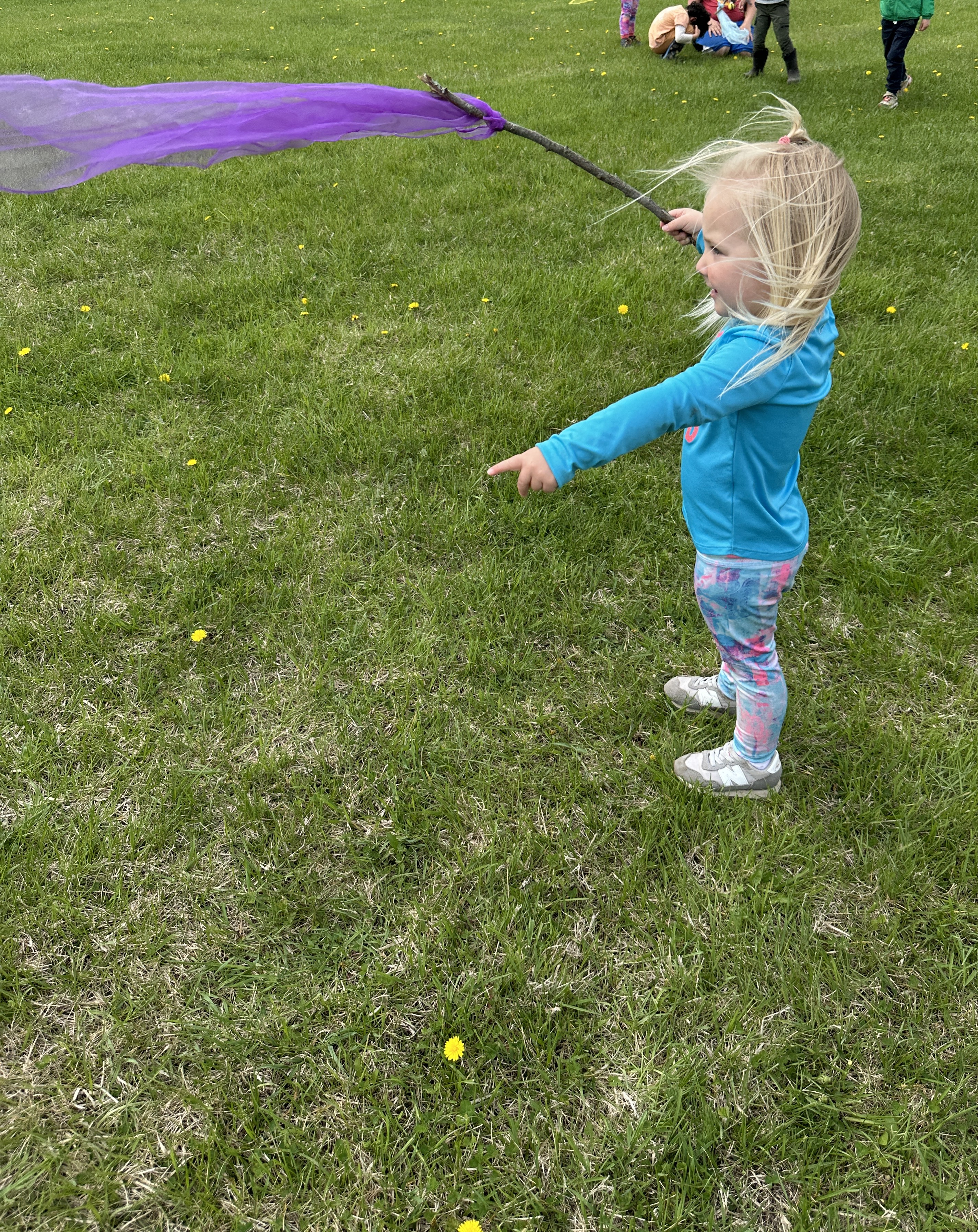 child playing with wind wand